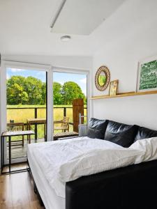 a bedroom with a bed and a balcony at Chalet Oslo in Bleckede