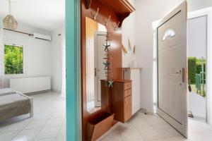 two images of a room with a door and a bedroom at A casa d'Irene in Amalias +23 photos