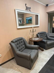 a living room with two couches and a table at Міні-готель RANDEVU in Zhytomyr