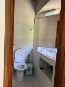 a bathroom with a toilet and a sink at Seta Forest House in Séta +33 photos