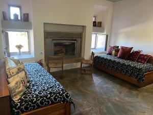 a living room with two beds and a fireplace at Seta Forest House in Séta