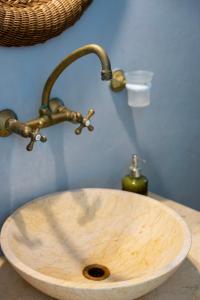 a wooden sink with a faucet on a counter at Sea view rooms in kardiani by TinosStay in Kardhianí