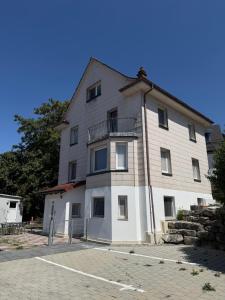 a large white building with a balcony at Ferienwohnung Trinh 1 in Überlingen