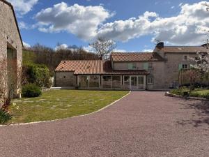 an exterior view of a house with a driveway at Domaine du Thie in Dirac