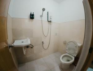 a bathroom with a shower and a toilet and a sink at New Modern Summer House in Moalboal