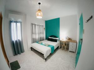 a bedroom with a bed and a desk in it at New Modern Summer House in Moalboal