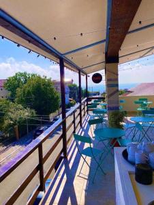 a patio with tables and chairs on a balcony at Sea View Premium in Costinesti