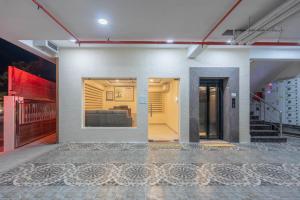 a living room with a couch in a building at Treebo Skanda Grande in Pondicherry