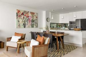 a kitchen and dining room with a table and chairs at Postcard on Sunrise in Sunrise Beach