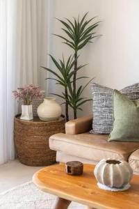 a living room with a couch and a table at Postcard on Sunrise in Sunrise Beach
