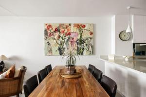 a dining room table with a potted plant on it at Postcard on Sunrise in Sunrise Beach +26 photos