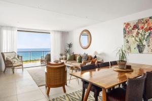 a living room with a table and a couch at Postcard on Sunrise in Sunrise Beach