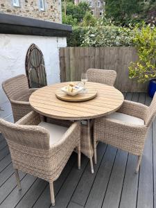 a wooden table and chairs on a patio at Rosevean Cottage St Agnes in St. Agnes
