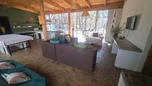 a living room with a couch and a table at Vulture's View 6 in Hartbeespoort
