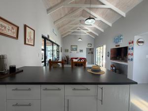 a kitchen with a counter with a hat on it at Sunset Sands in St. Helena Bay +21 photos