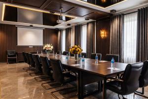 a large conference room with a long table and chairs at Valor Hotel in Tashkent