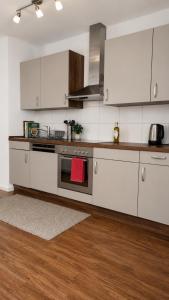 a kitchen with white cabinets and a stove at Central Studio Apartment with free BaselCard - Magritte in Basel