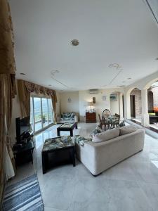 a large living room with a couch and a table at Ocean Pearl Villa in Anse Royale