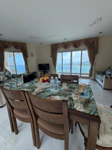 a dining room with a table and chairs with a view at Ocean Pearl Villa in Anse Royale