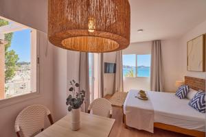 a living room with a table and a bedroom at INNER Niza Paguera in Paguera +100 photos