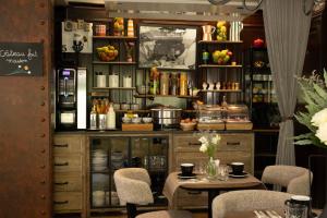 a restaurant with a table and chairs in a room at Hotel London in Paris