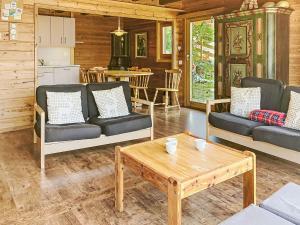 a living room with two couches and a coffee table at Chalet Château Lapin by Interhome in Verbier