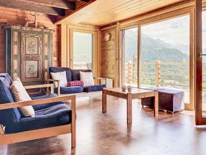 a living room with couches and a table and a window at Chalet Château Lapin by Interhome in Verbier
