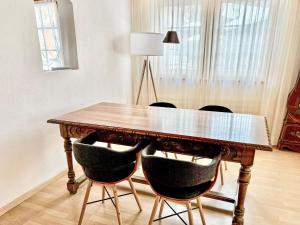 a dining room table with chairs and a lamp at Apartment Diana by Interhome in Münster +12 photos