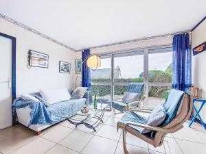 a living room with chairs and a couch and a window at Holiday Home TY Greg by Interhome in Crozon
