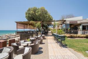 a row of tables and chairs on the beach at A casa d'Irene in Amalias