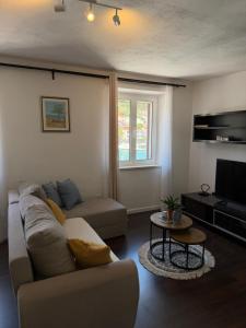 a living room with a couch and a tv at Apartmani Brač in Pučišća