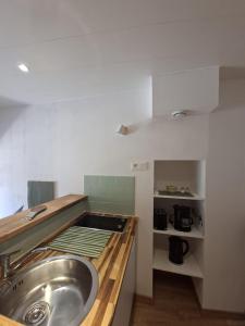 a kitchen with a sink and a counter top at La Voûte - Clim et Gare 5 min in Rumilly +12 photos