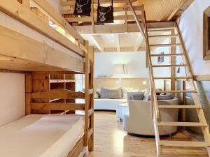 a room with a bunk bed and a living room at Apartment Les Cimes by Interhome in Les Crosets