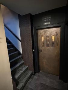 a staircase leading up to a door with a stair case at 4 Rooms Pixel A in Herzebrock