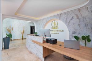 a reception desk in a room with a stone wall at Turquoise Retreat Spa & Wellness in Kaş +70 photos