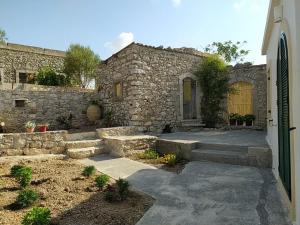 a stone building with a door and some stairs at Matsipeti in Kythira