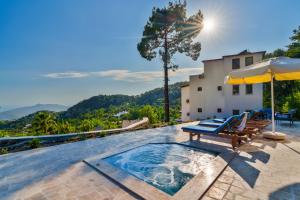 a pool with a table and chairs and an umbrella at Turquoise Retreat Spa & Wellness in Kaş