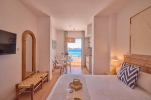 a bedroom with a bed and a living room at INNER Niza Paguera in Paguera