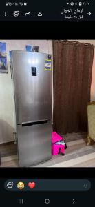 a stainless steel refrigerator sitting in a kitchen at Private Bella Rum Villa with Garden in Marsa Matruh