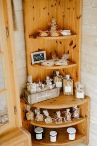 a wooden shelf with cookies and other items on it at Apartment Hof Obertalgut by Interhome in Teuffenthal +17 photos