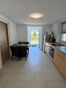 a kitchen with a table and a dining room at Ferienwohnung Trinh 1 in Überlingen +6 photos