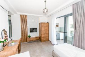 a room with a bed and a desk and a tv at Bumax Apartments in Ulcinj