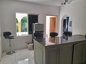 a kitchen with a counter and two stools in it at Skyview Palace in Montpelier