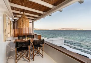 a balcony with a table and chairs on a yacht at Captain Zeppos in Pollonia