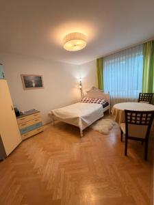 a bedroom with a bed and a table and a window at Villa Apartments in Palanga +71 photos
