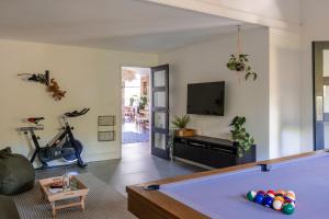 a living room with a pool table and a tv at Northside in Kingsbridge