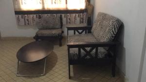 a room with two chairs and a table and a chair at ESPACE iDIMA 2026 in Djérigbé