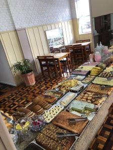 a buffet table with many different types of food at Grande Hotel Torres in Torres +11 photos
