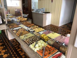 a buffet line with many different types of food at Grande Hotel Torres in Torres