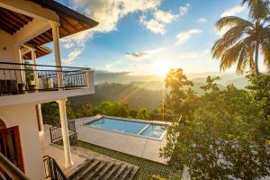 a villa with a pool and a view of the mountains at Sunset Hill Resort in Kandy